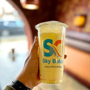 a hand holding a cup of coffee