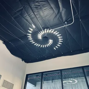 a circular light fixture suspended from the ceiling