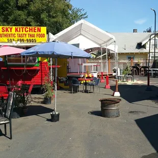 the outside of a restaurant with tables and umbrellas