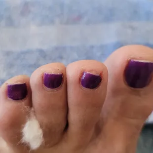 Cut crooked,  no polish on the tip of nail. Polish smeared around cuticle.