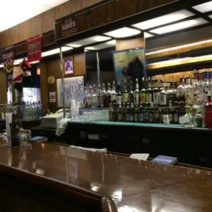 a bar with many bottles of alcohol