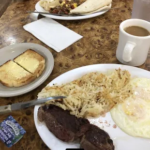 Steak and eggs with hash browns and huevos rancheros.