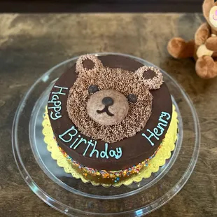 a birthday cake with a teddy bear