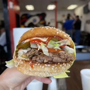 Single Burger with cheese, grilled onions and ketchup