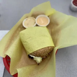 a sandwich wrapped in yellow paper