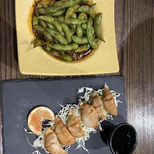 a plate of sushi and a bowl of soy beans
