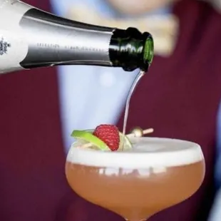a bartender pouring a drink