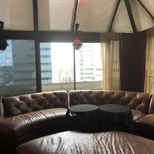 a view of a living room with leather furniture