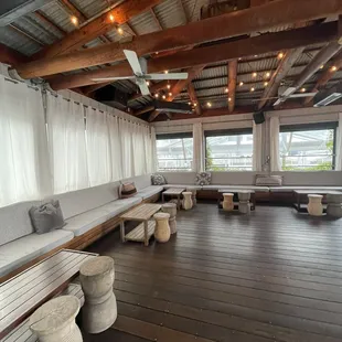 a living room with a wooden floor and large windows