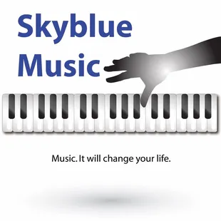 a hand touching a piano keyboard