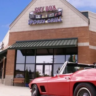 a red sports car parked in front of the building