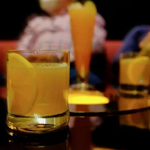 a glass of orange juice on a table