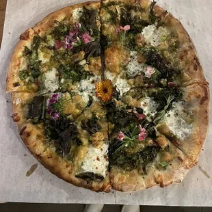 a whole pizza with broccoli and cheese