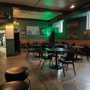 a dimly lit restaurant with tables and stools