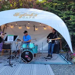 a group of people playing music under a tent