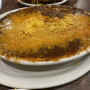 Special appetizer layered with cream cheese, chili, cheese