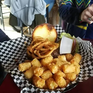 a basket of onion rings and a burger