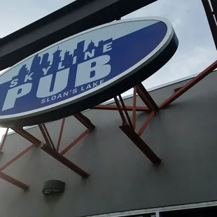 a blue and white sign on the side of a building