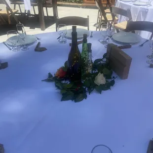 Our table setting that we provided. Bottles with fairy lites, and our homemade table number.