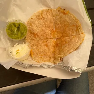 Quesadilla with a side of sour cream and avocado