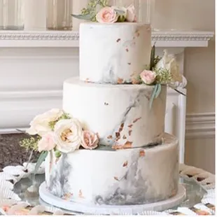 Hand Painted Marble with fluttering on trend Edible Gold Leaf specks and Fresh Flower accents.