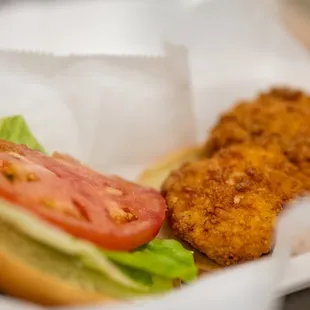 a chicken sandwich with lettuce and tomato