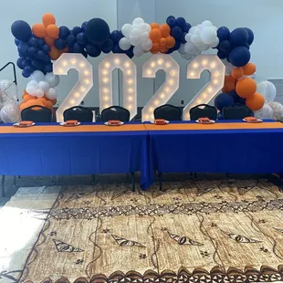 Senior Table with 2022 backdrop on top of stage provided by the Skyview Event Center