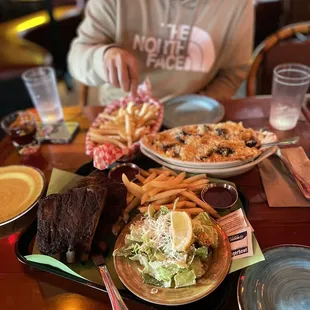Half rack of ribs meal (we chose ceasar salad + fries as our two sides), large basket of fries, boat of mac &amp; cheese, added brisket.