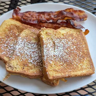 a plate of french toast and bacon