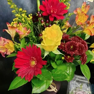 Yellow roses, red Gerbera daisies with fall chrysanthemums