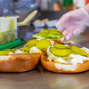 a person preparing sandwiches