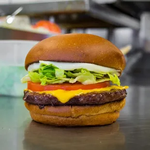 a cheeseburger with lettuce and tomato