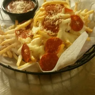 a basket of pizza and fries