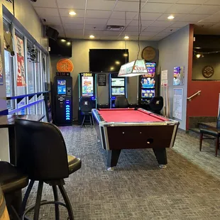a pool table and arcade machines