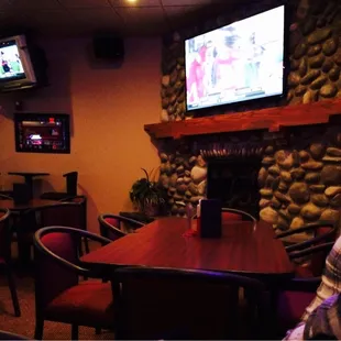 Fireplace and one of the TVs