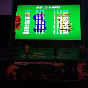 an arcade machine with a green screen
