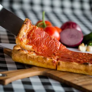 a slice of pizza on a cutting board