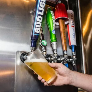 a person holding a beer