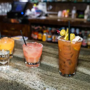 three cocktails on a bar