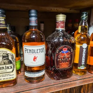 a shelf full of liquor bottles