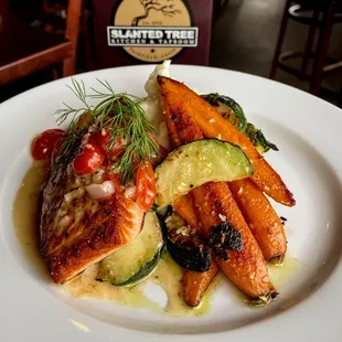 Catch of the Day: seasoned and grilled wild caught salmon, Blanc sauce, sautéed seasonal vegetables, and creamy mashed potatoes.