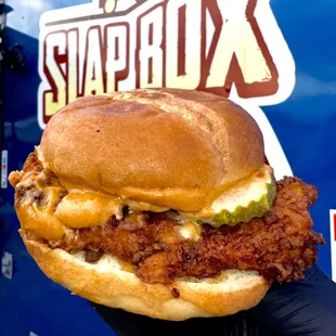 a hand holding a sandwich