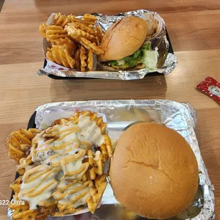 two trays of fries and a hamburger