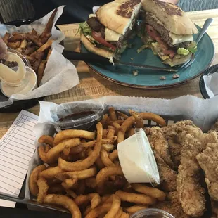 a plate of fried chicken, fries, and a sandwich