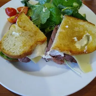 a roast beef sandwich and a salad