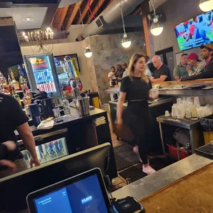 a busy bar with people in the background