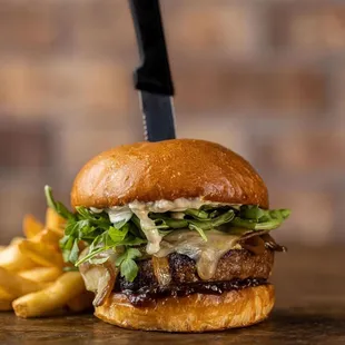 Hi-Brow Burger! Angus beef, melted swiss &amp; blue cheeses, arugula, caramelized onions, horseradish, bacon-jalapeño jam, roasted garlic aioli
