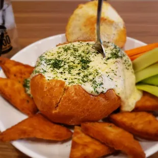 Vampire Dip!! Roasted garli  and artichoke hearts with creamy melted cheese in sourdough bread bowl