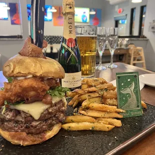 The whale burger, garlic fries, and champagne