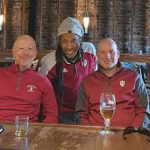 two men sitting at a bar